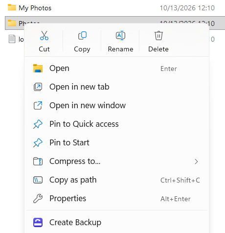 The Windows 11 File Explorer menu for a folder named Photos, with Create Backup and the BackupKit icon below Properties